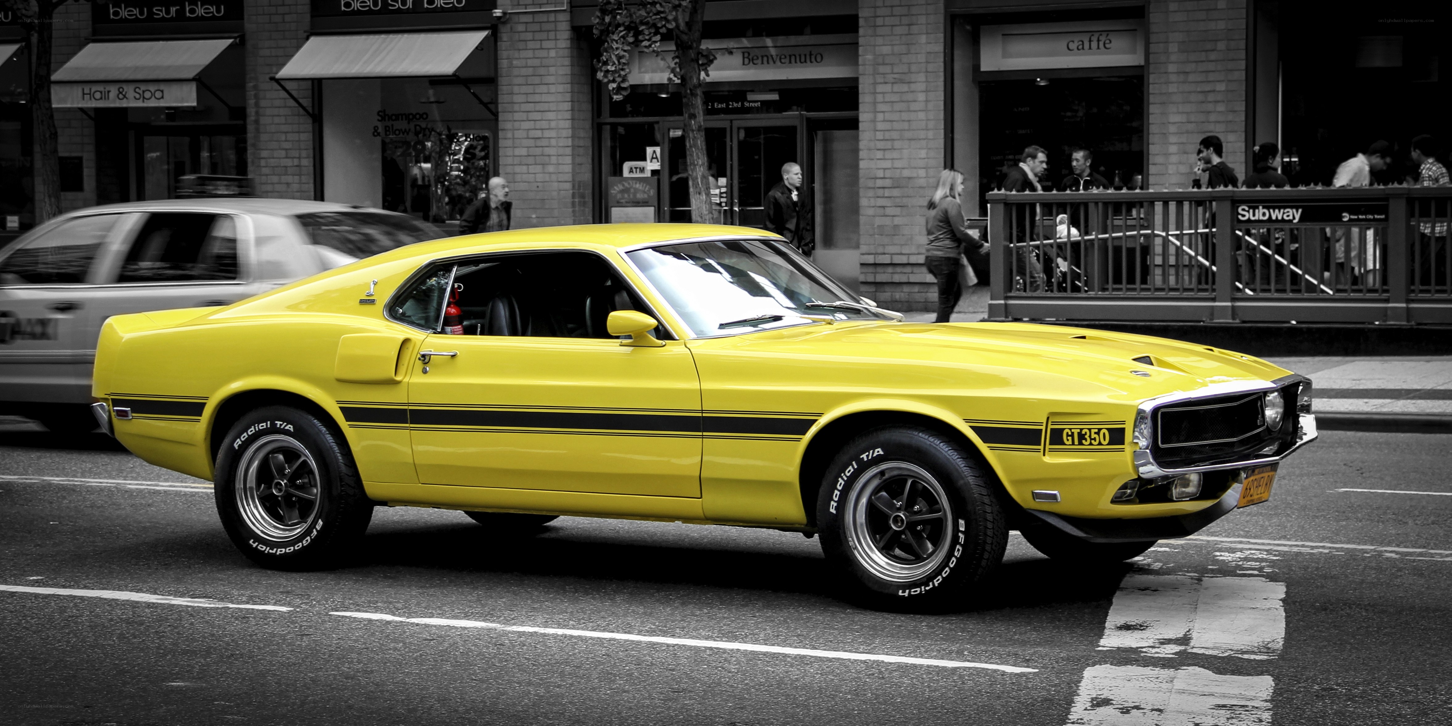 Yellow muscle car on city street