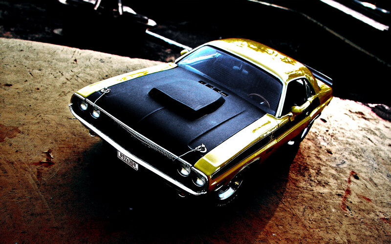 yellow muscle car on concrete