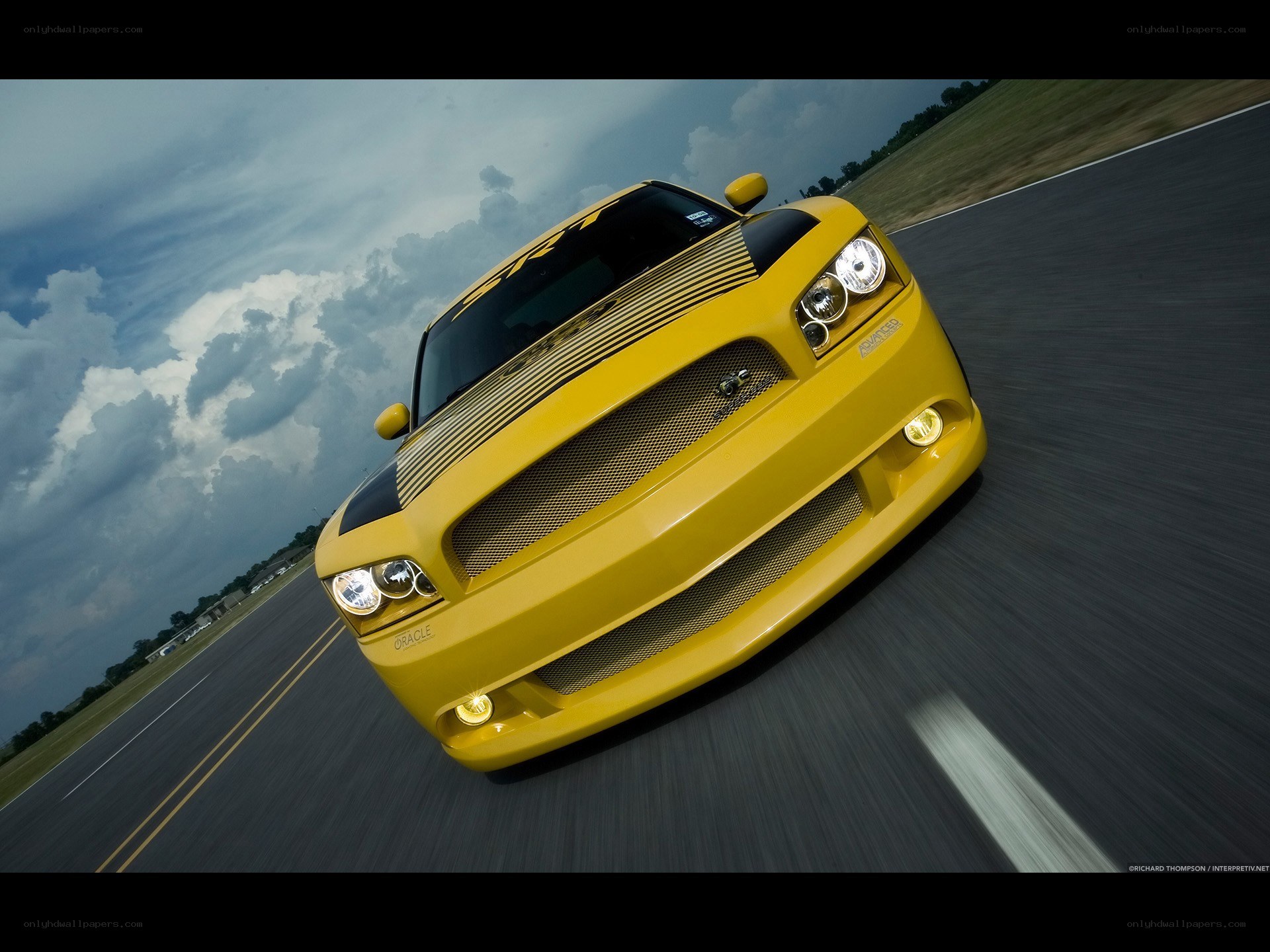 yellow muscle car on track