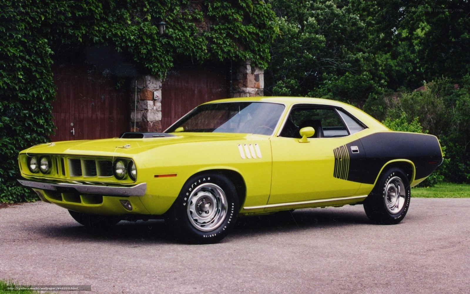 Yellow muscle car parked outside