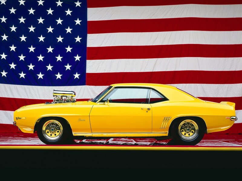 Yellow muscle car with American flag