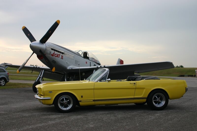 Yellow Mustang and vintage plane