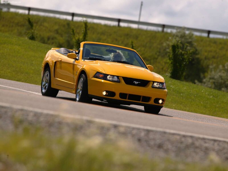 Yellow Mustang convertible on road