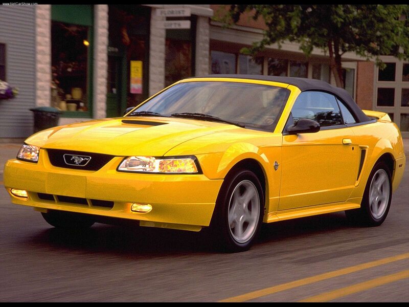 yellow mustang convertible on street