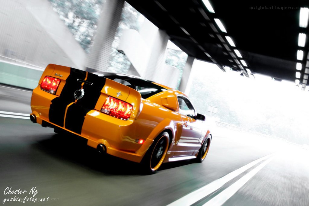 Yellow Mustang in motion