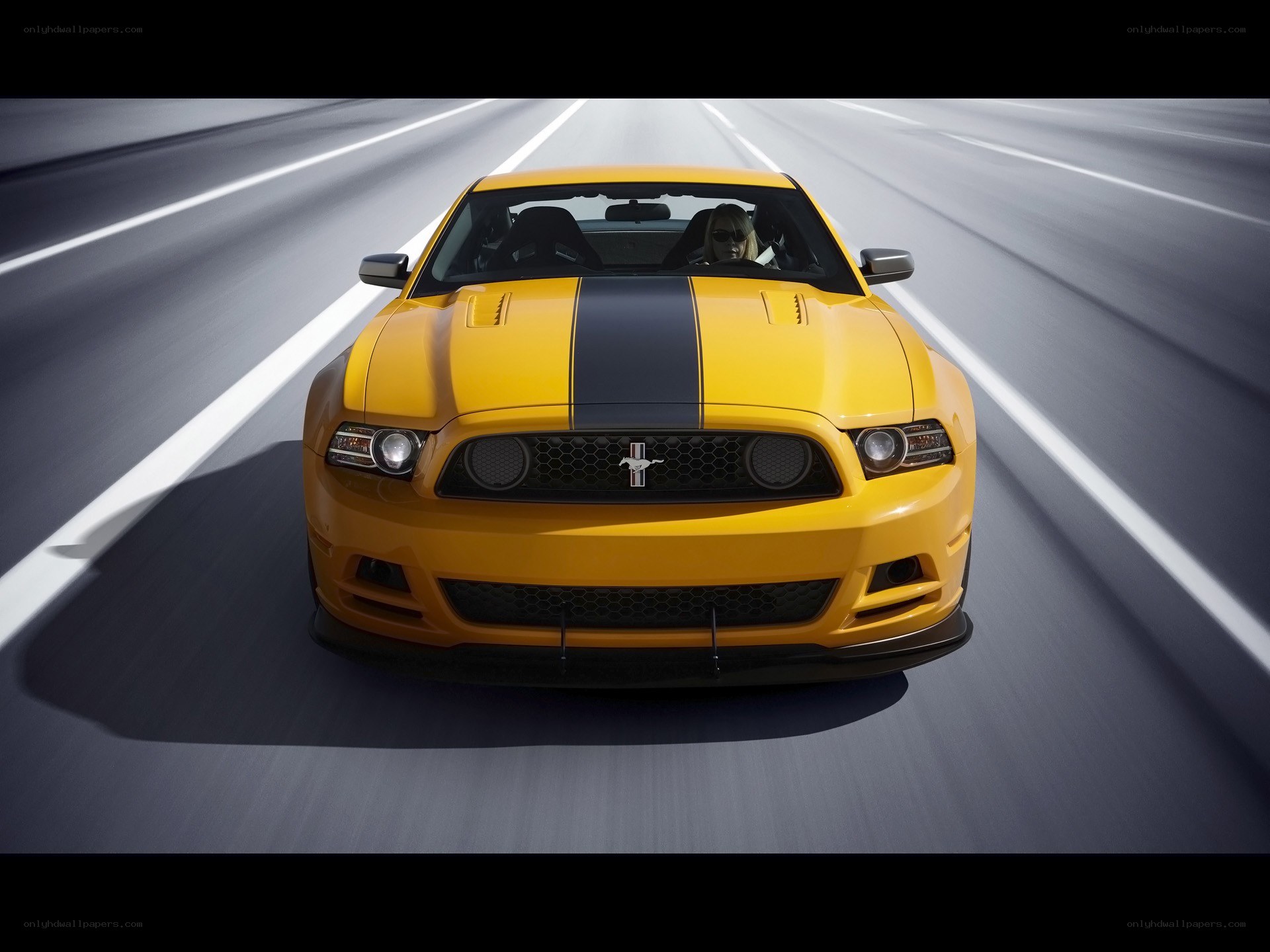 Yellow Mustang on a highway