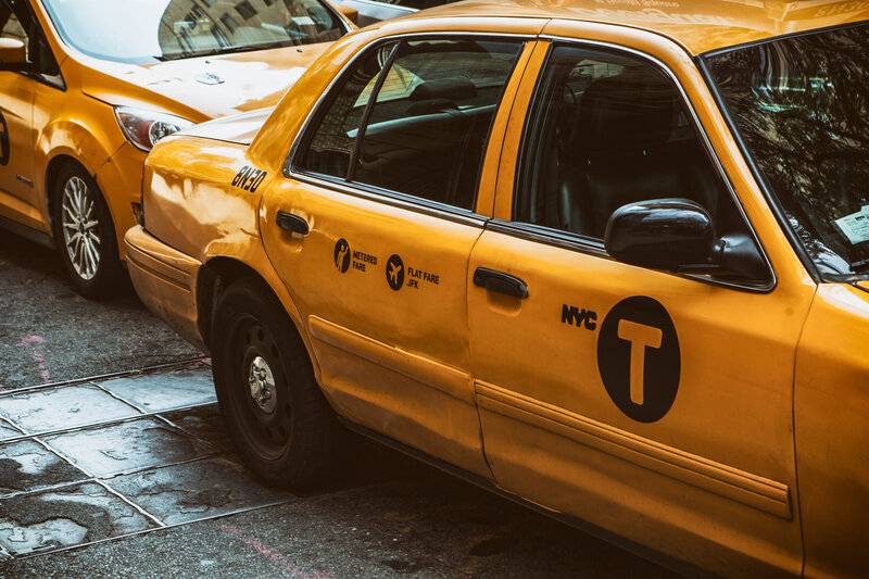 Yellow NYC taxi on city street
