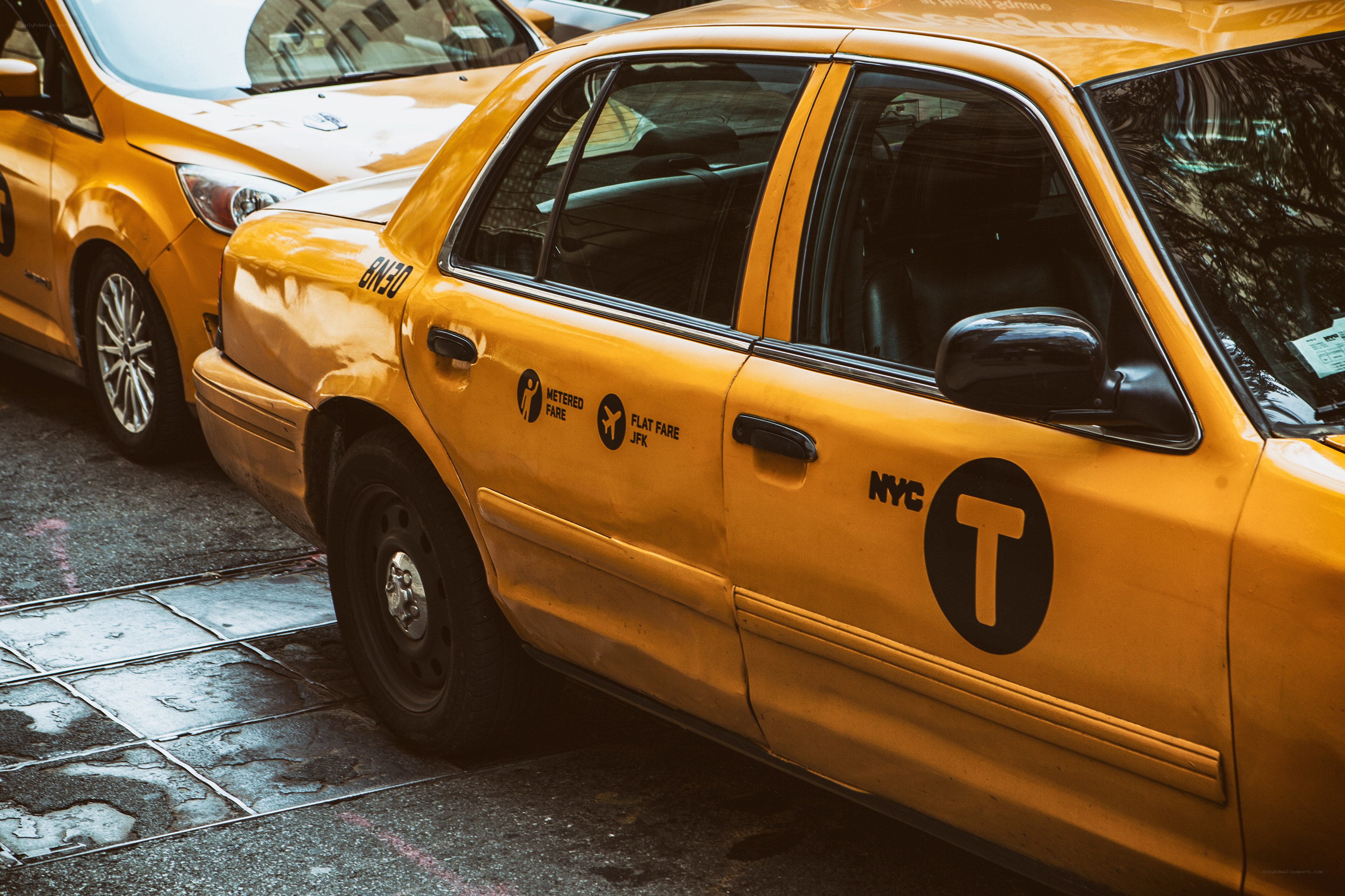 Yellow NYC taxi on city street