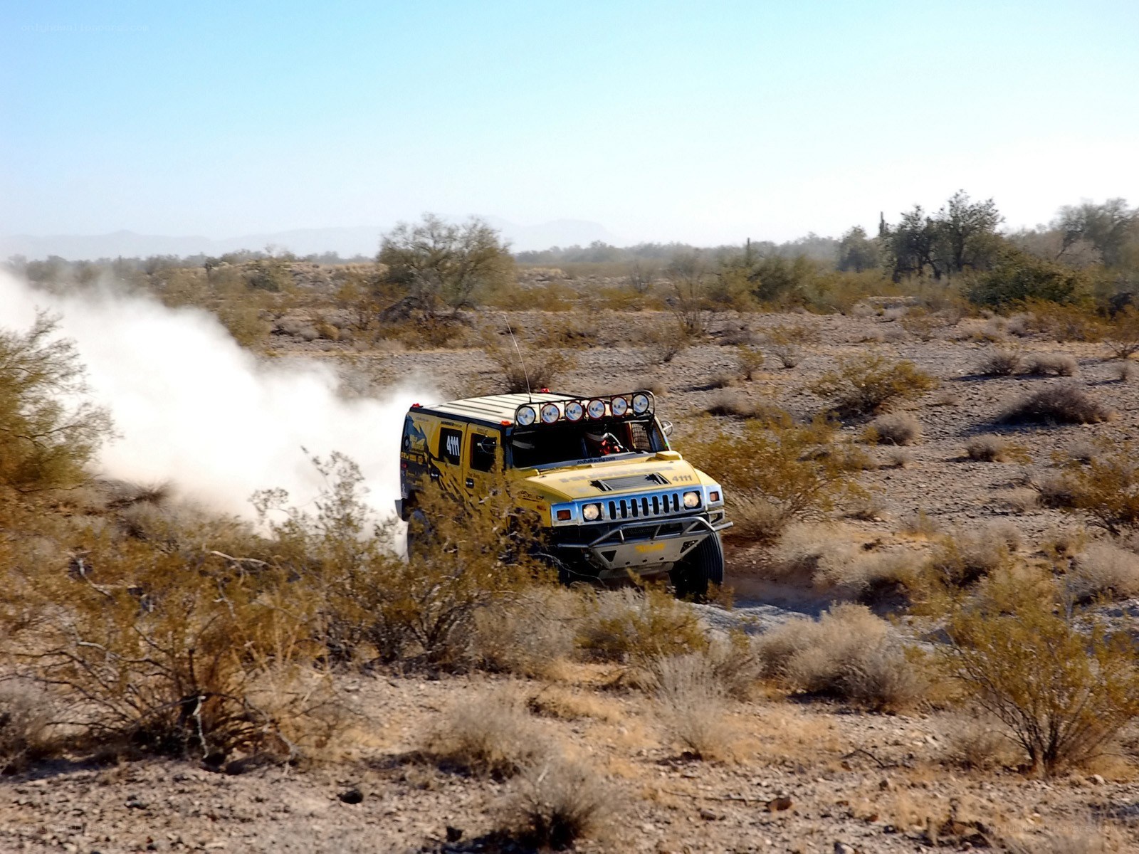 Yellow off-road vehicle in desert