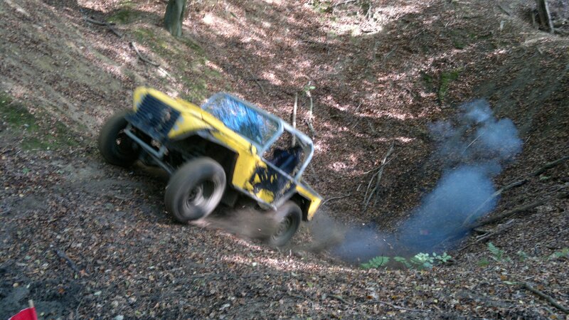 Yellow off-road vehicle on a forest slope