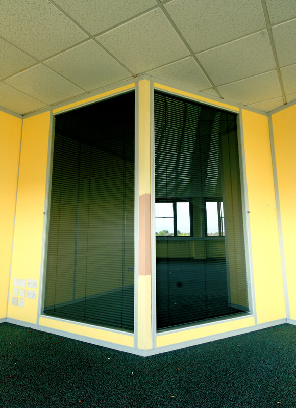 yellow office corner with glass walls