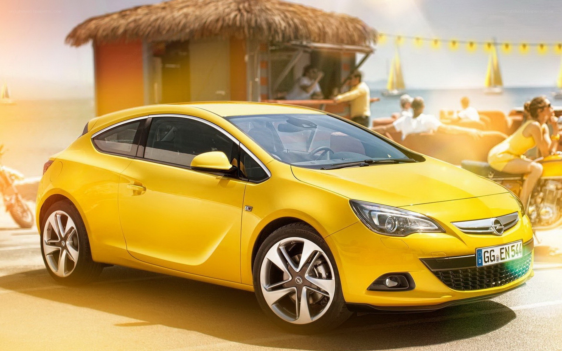 Yellow Opel Astra car at beach