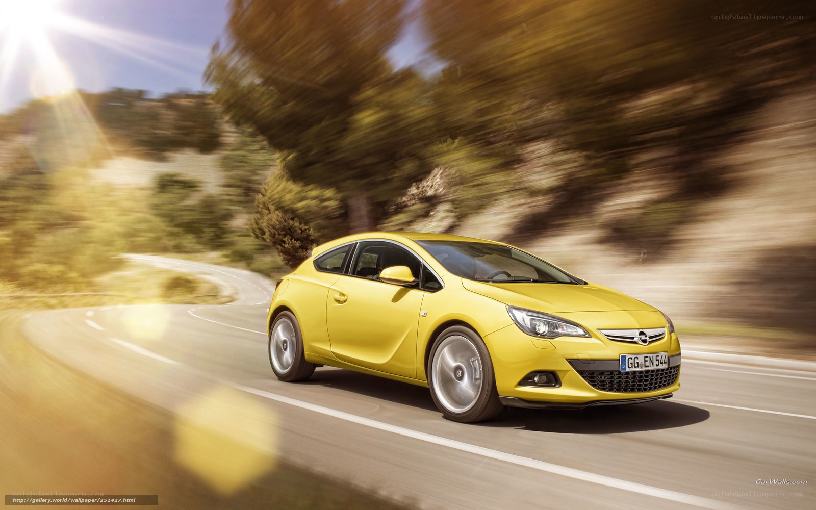 yellow opel astra driving on road