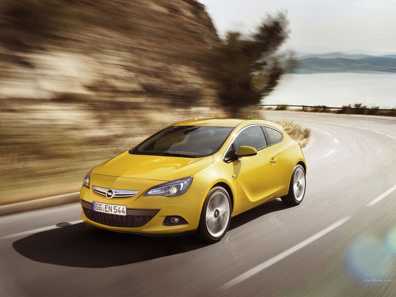 yellow opel astra gtc in motion