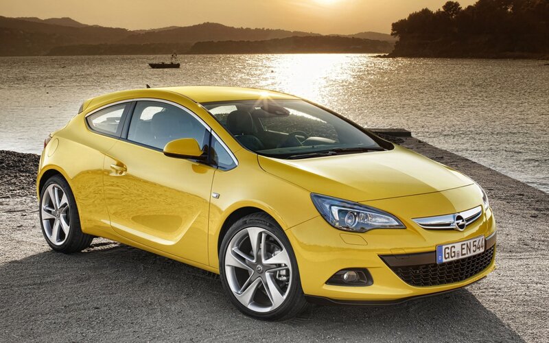 Yellow Opel Astra parked by the water