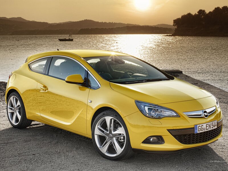 Yellow Opel Astra parked by the water