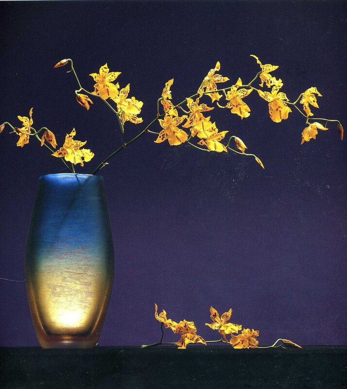 Yellow orchids in a blue vase
