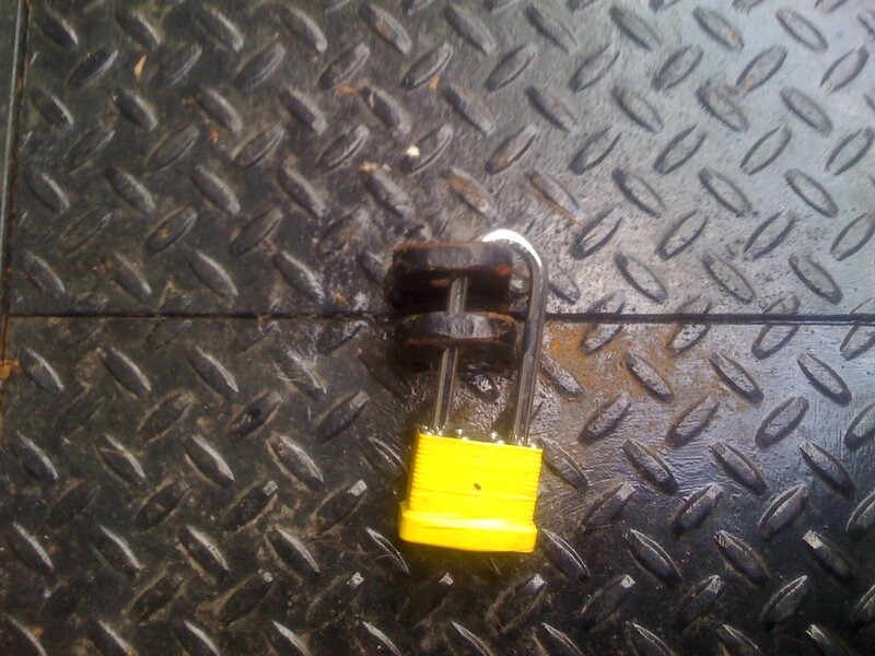 Yellow Padlock on Metal