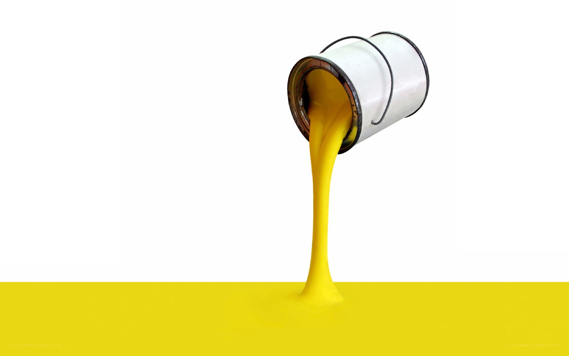 yellow paint pouring from a can