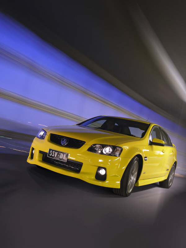 Yellow performance sedan in motion