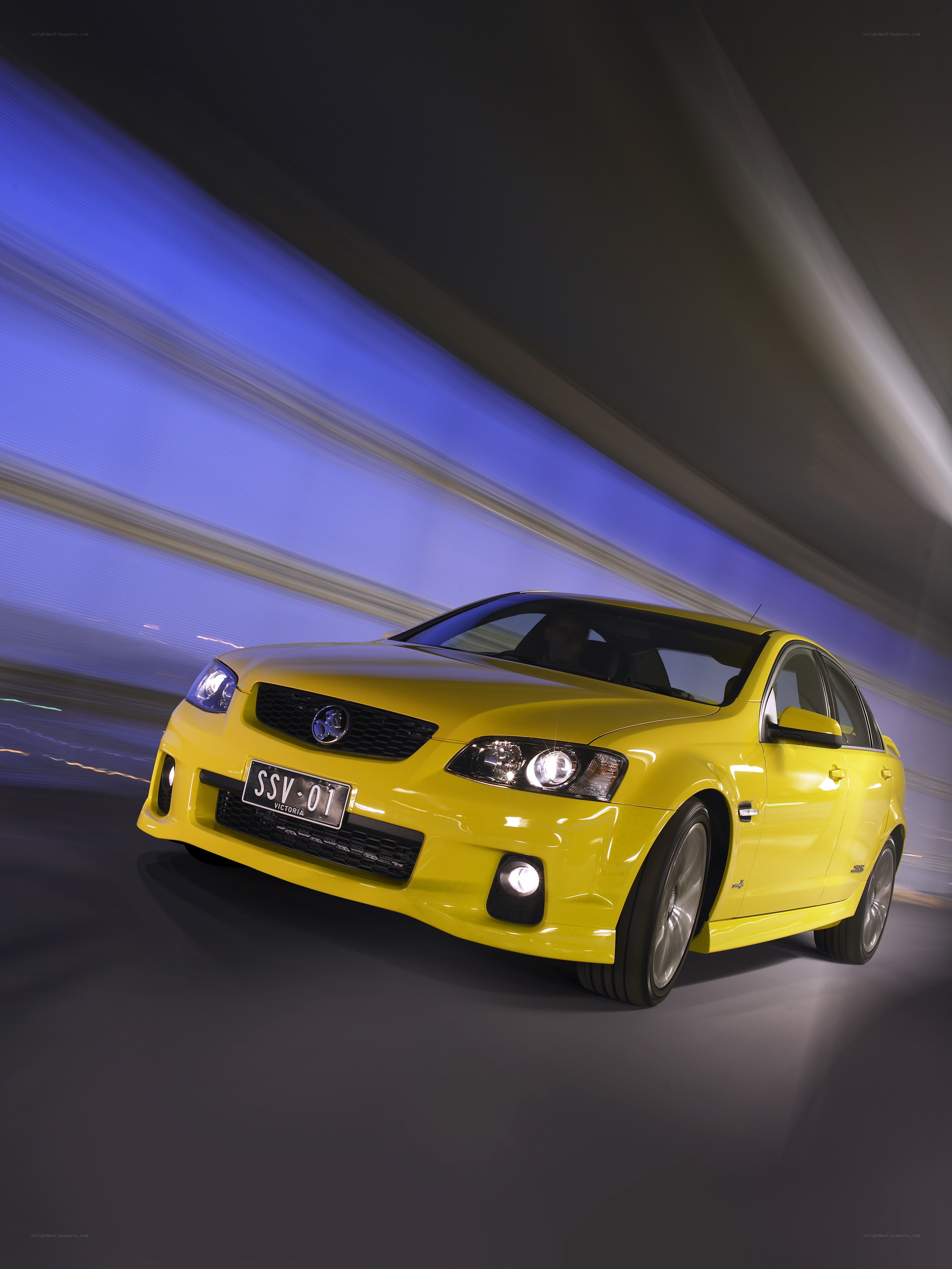 Yellow performance sedan in motion
