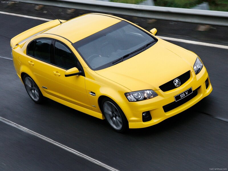yellow performance sedan on road