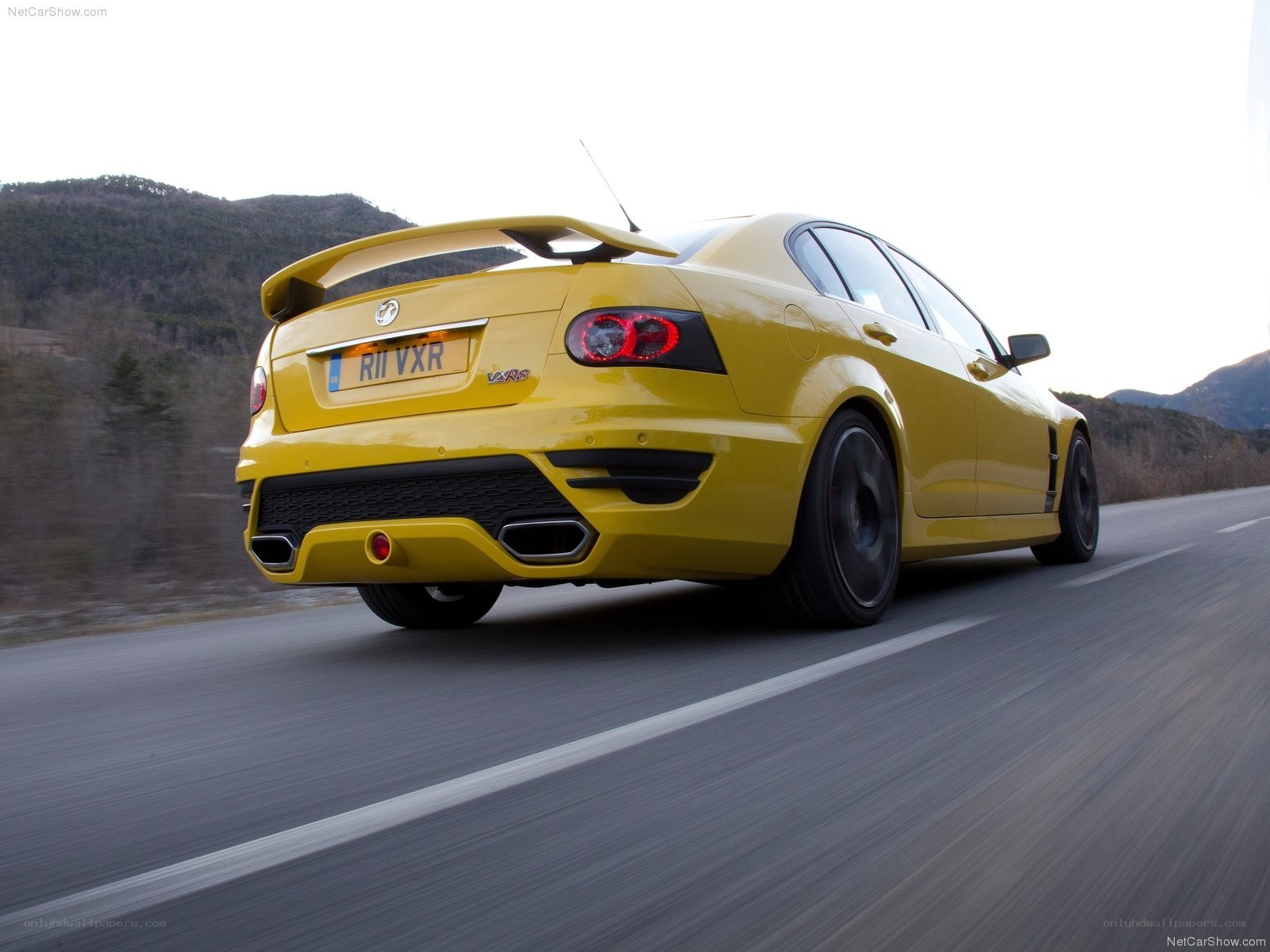 yellow performance sedan on road