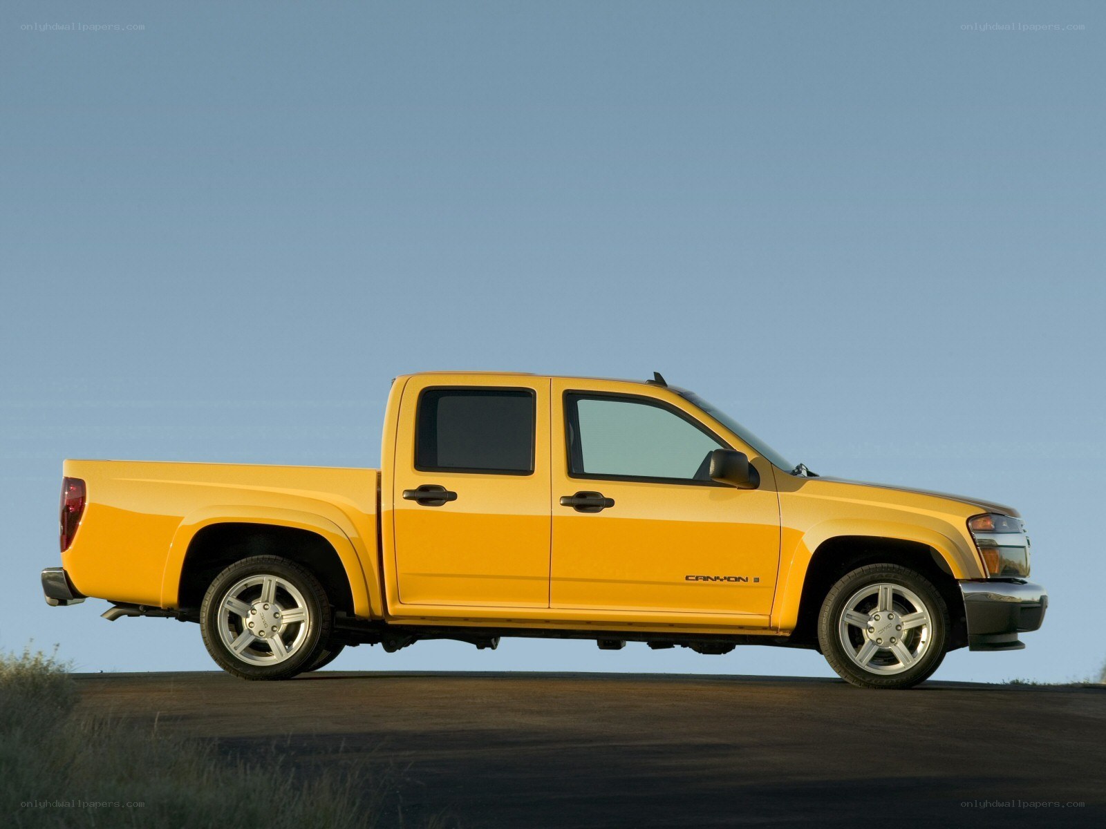 yellow pickup truck on road