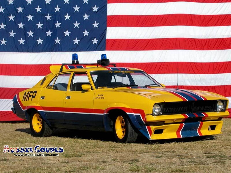 Yellow police car with American flag