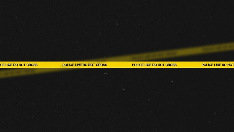 yellow police tape on dark background