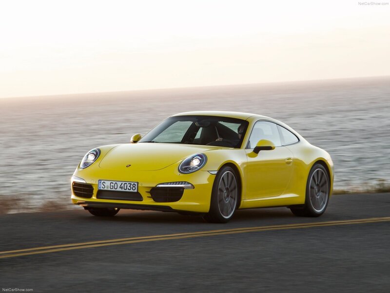 Yellow Porsche 911 on coastal road