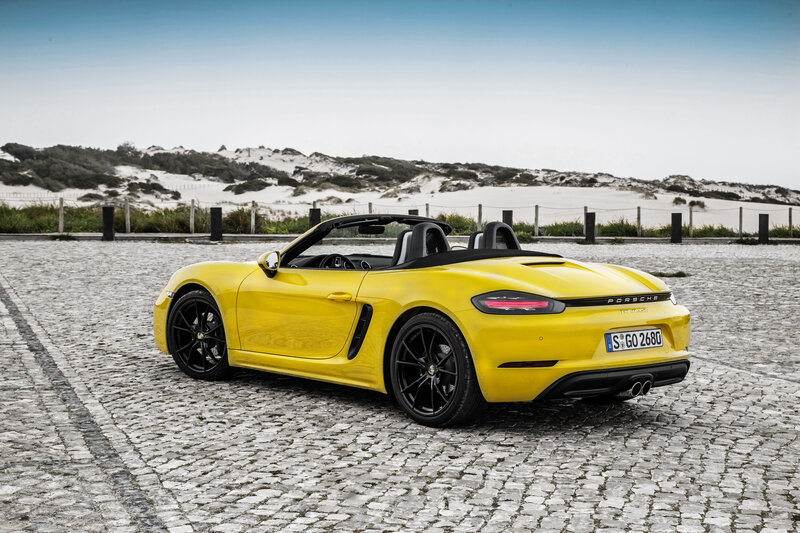 Yellow Porsche Boxster on cobblestones