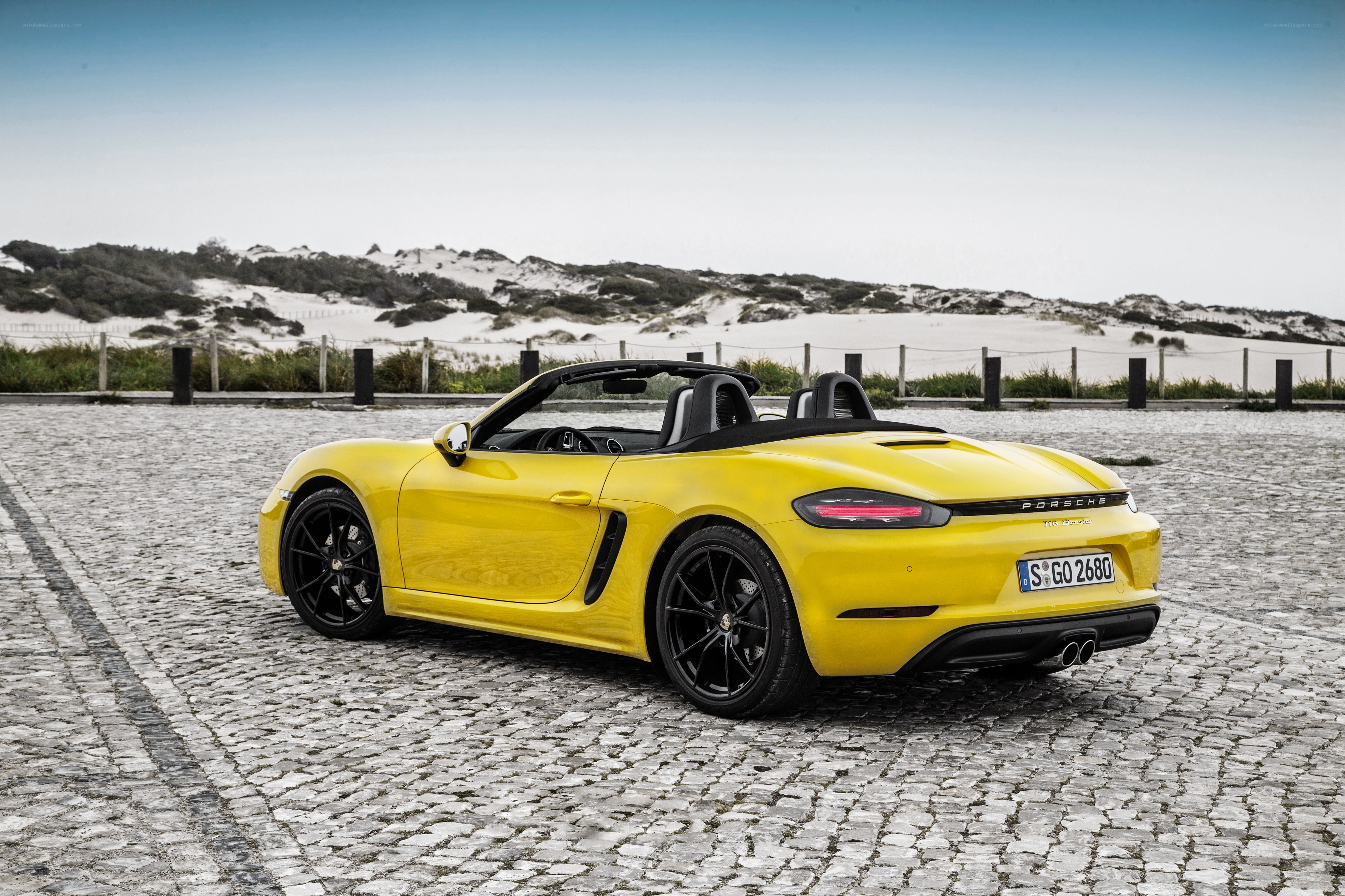 Yellow Porsche Boxster on cobblestones