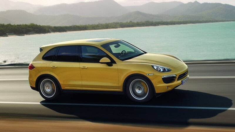 Yellow Porsche Cayenne in motion