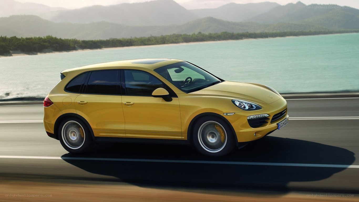 Yellow Porsche Cayenne in motion