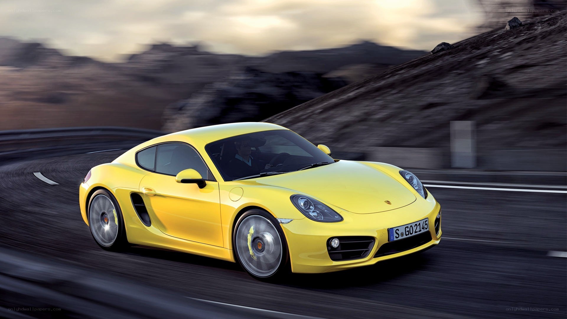 Yellow Porsche Cayman in motion