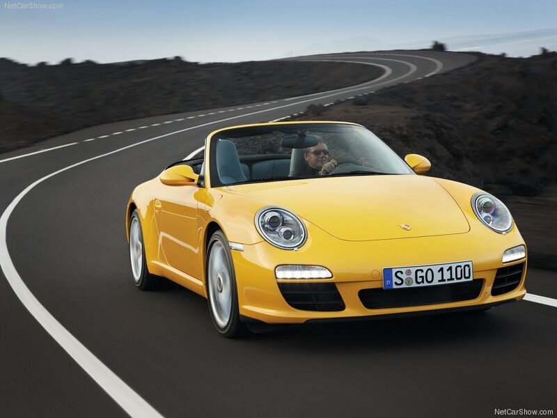 Yellow Porsche driving on a winding road