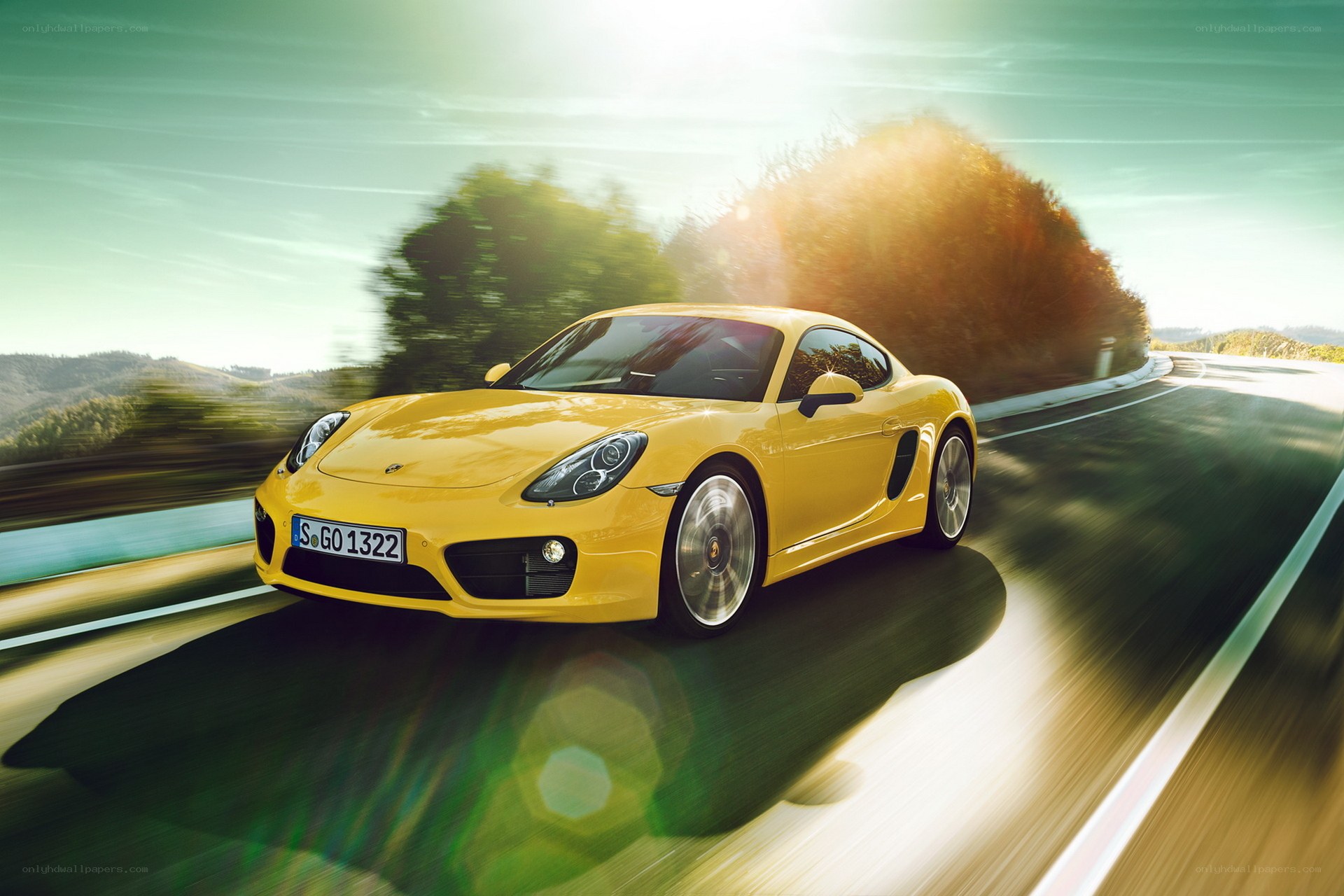 Yellow Porsche driving on road