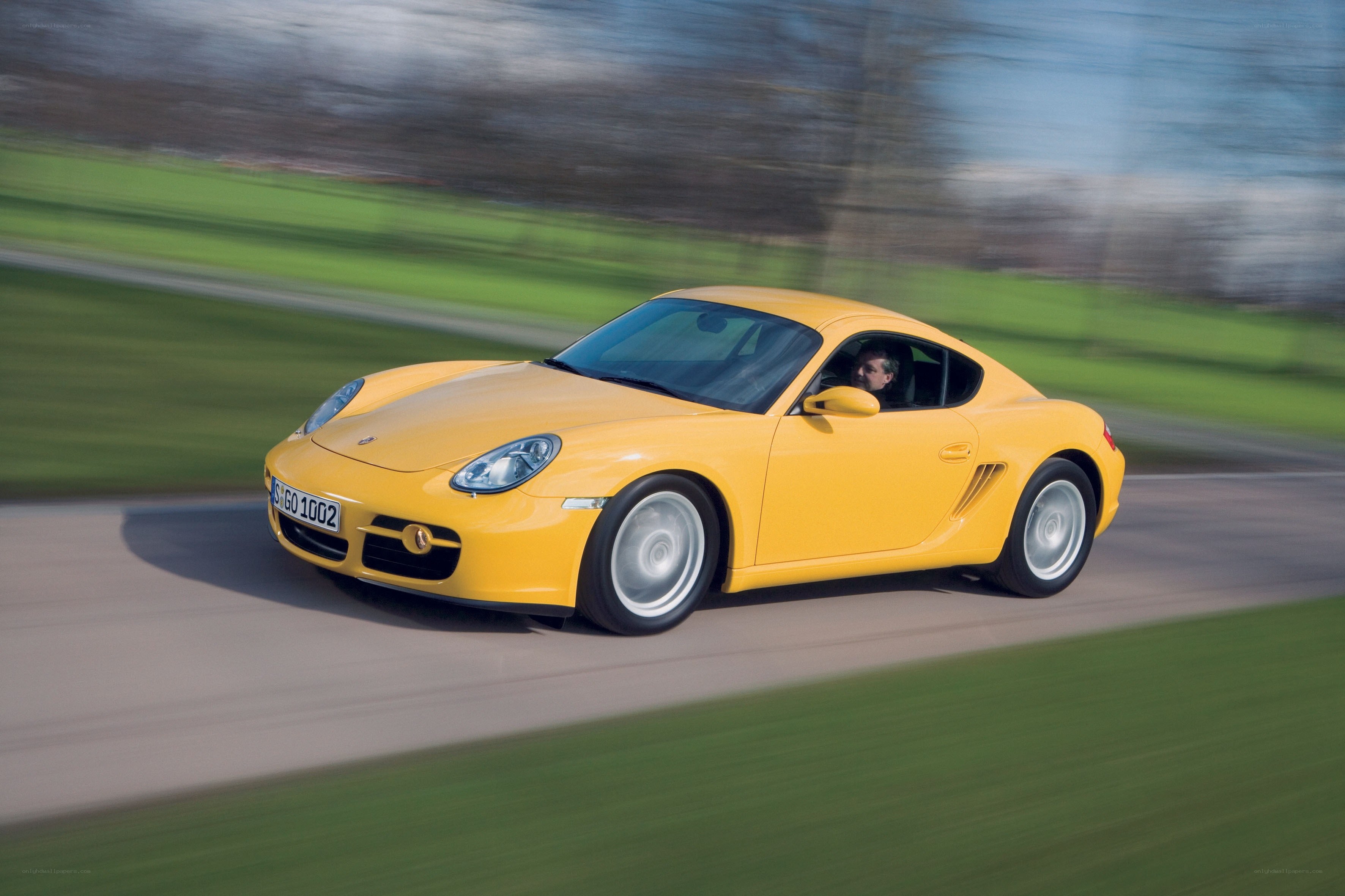 Yellow Porsche in motion