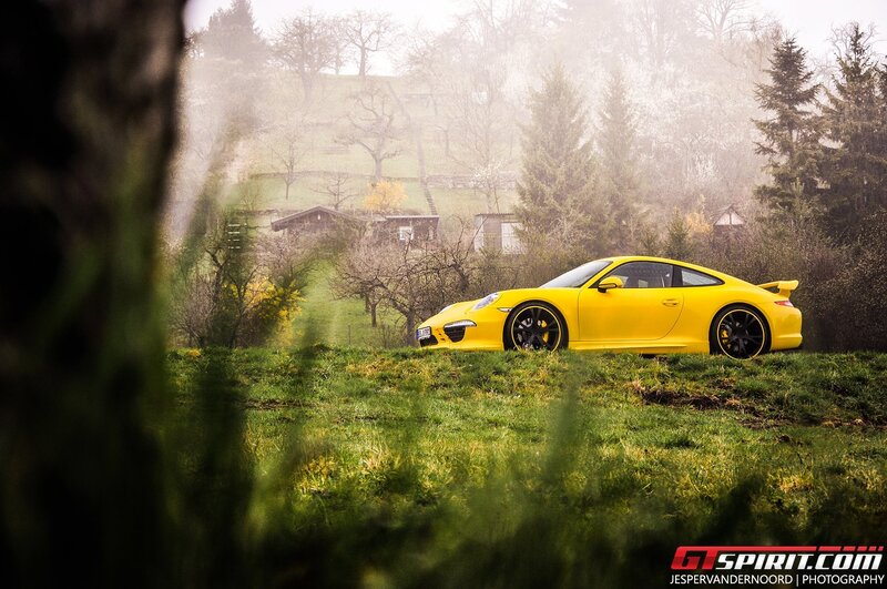 Yellow Porsche on a misty hill