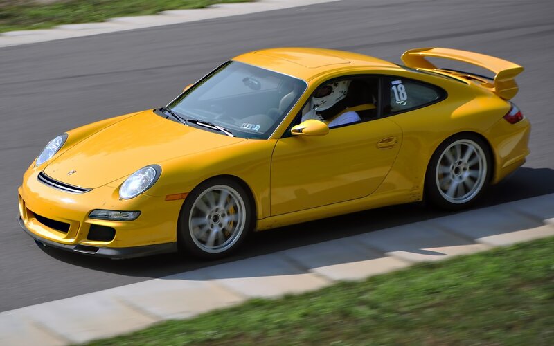 Yellow Porsche on a racetrack