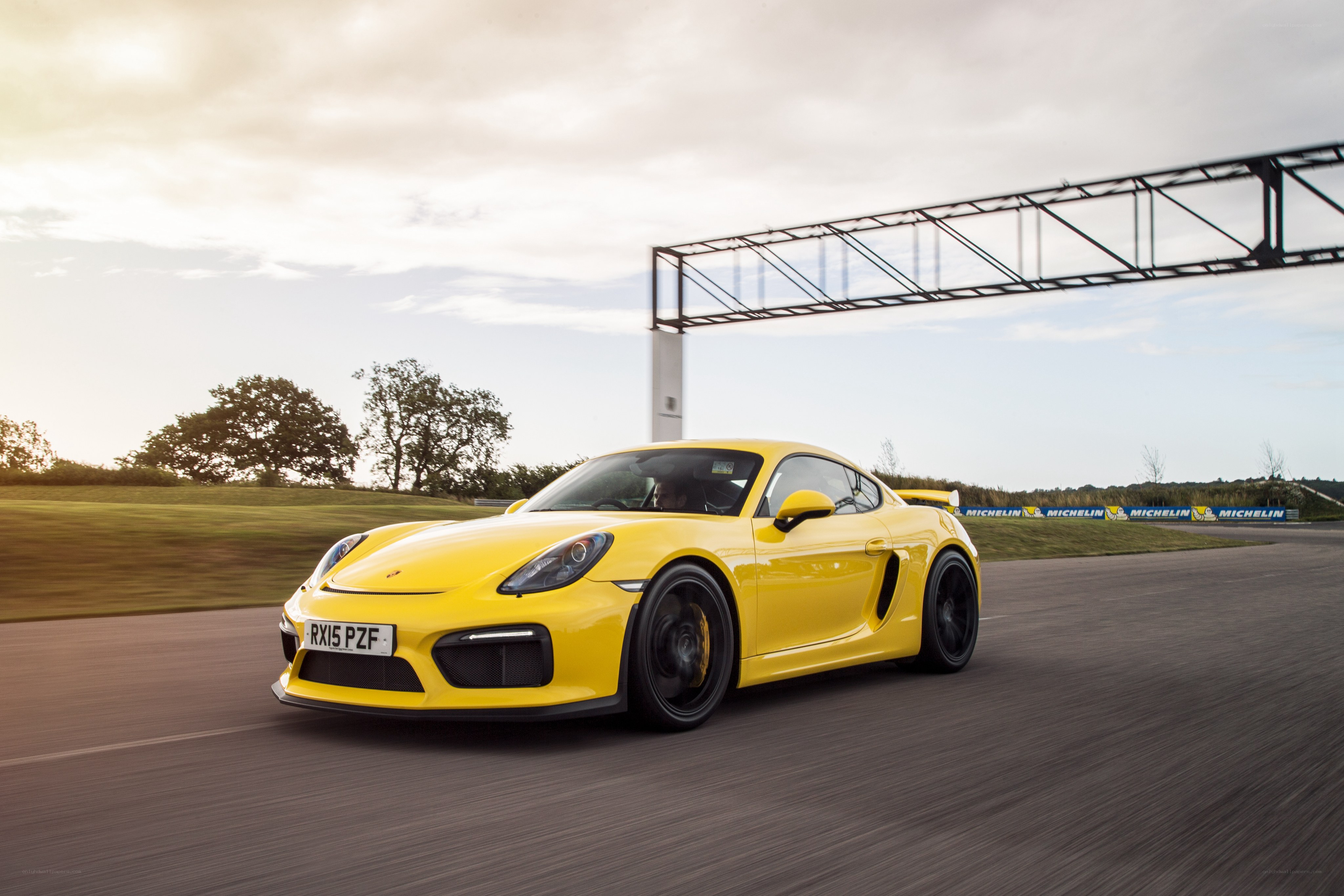 Yellow Porsche on a racetrack