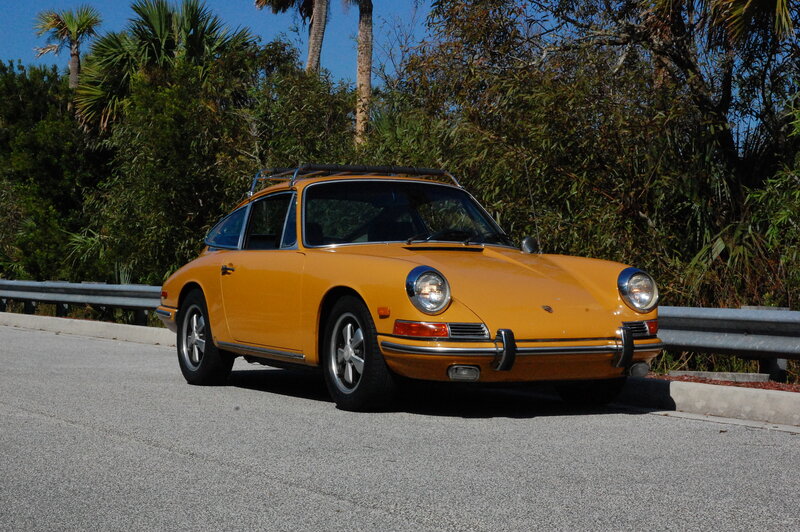 Yellow Porsche on a sunny road