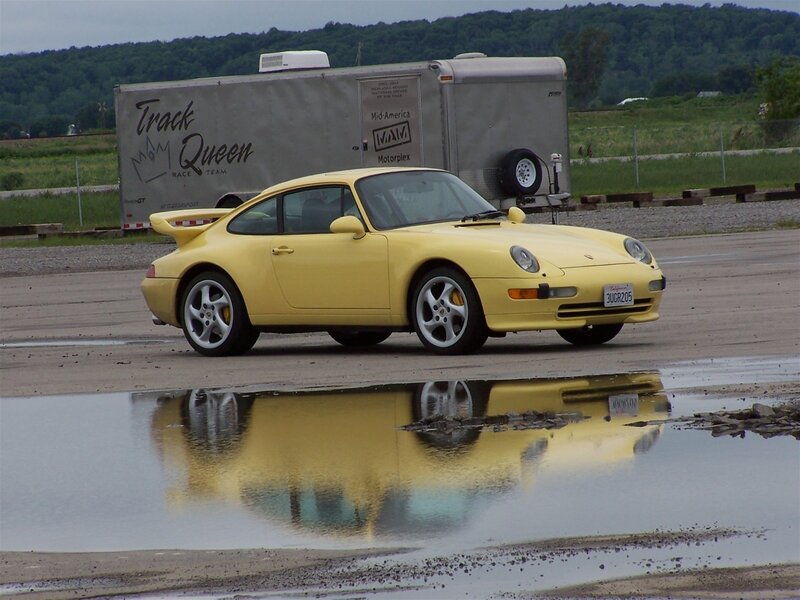 Yellow Porsche on a wet track