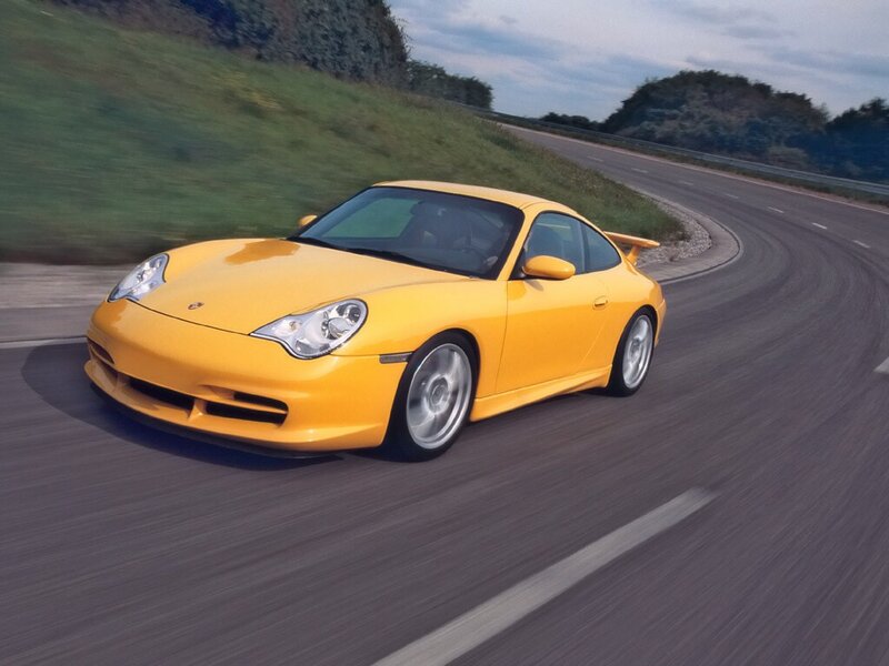 Yellow Porsche on a winding road