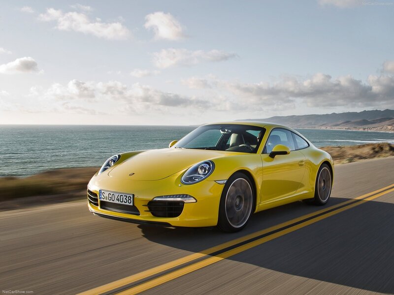 Yellow Porsche on coastal road