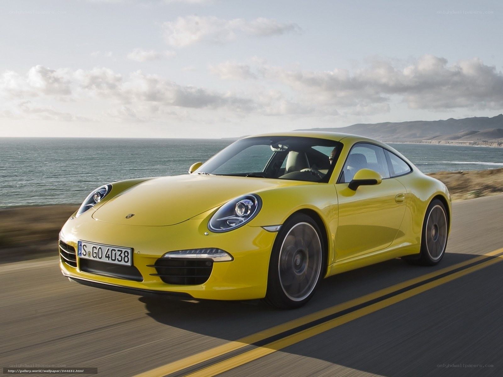 Yellow Porsche on coastal road