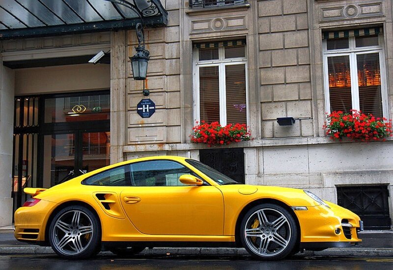 yellow porsche parked on street