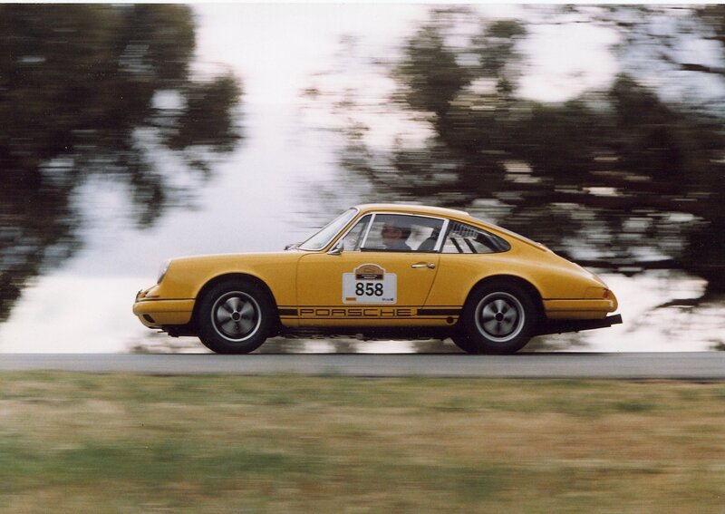 Yellow Porsche racing on track