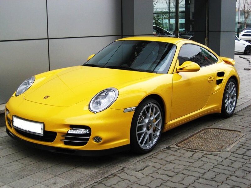 yellow porsche sports car